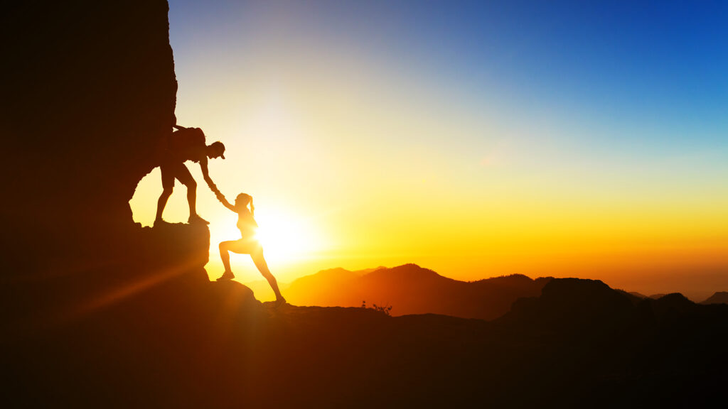 Image of two hikers ascending a mountain